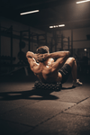 Person lying on foam roller on gym floor upper back
